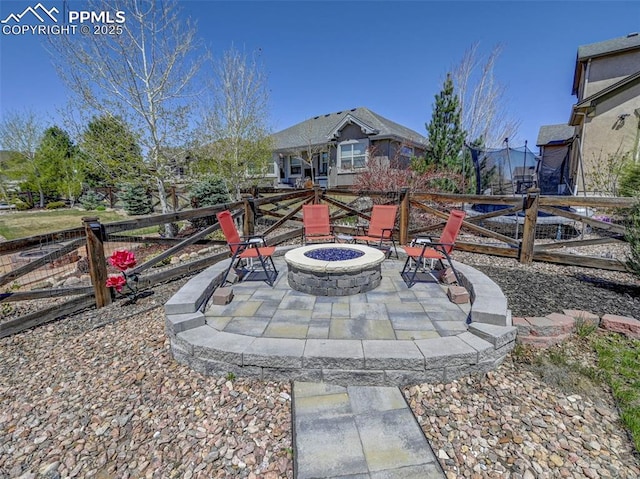 view of yard featuring a fire pit, a patio area, and fence