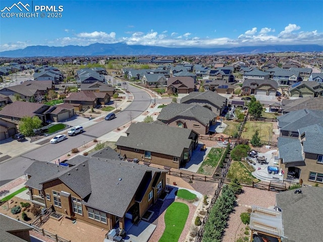 drone / aerial view featuring a residential view and a mountain view