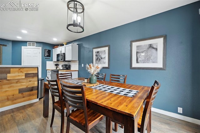 dining room with baseboards, recessed lighting, wood finished floors, and visible vents