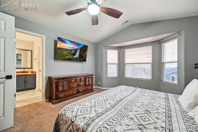 carpeted bedroom with visible vents, a sink, vaulted ceiling, and multiple windows