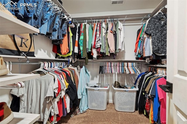 walk in closet featuring visible vents and carpet