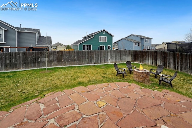 view of patio with a residential view, a fire pit, and a fenced backyard