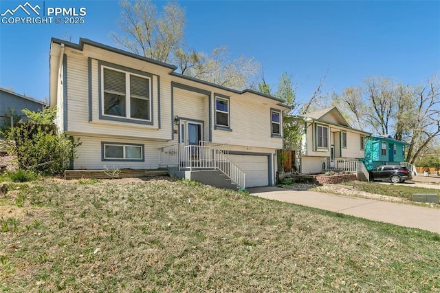 2706 N Chestnut St, Colorado Springs, CO 80907 - bi-level home with a garage, a front lawn, and driveway