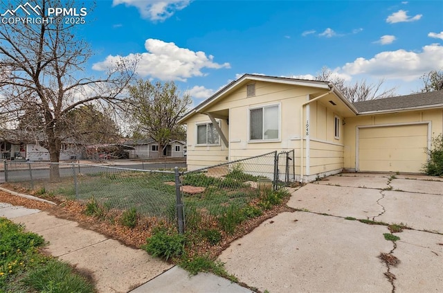 view of front of home featuring a garage, fence, and concrete driveway