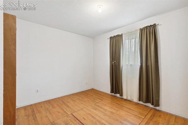 unfurnished room featuring light wood-style flooring
