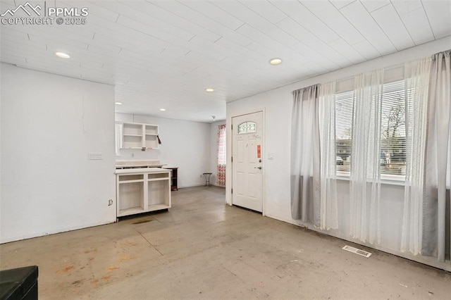 unfurnished living room featuring recessed lighting, visible vents, and plenty of natural light