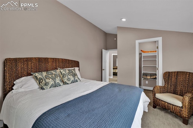 carpeted bedroom with recessed lighting, a walk in closet, and lofted ceiling