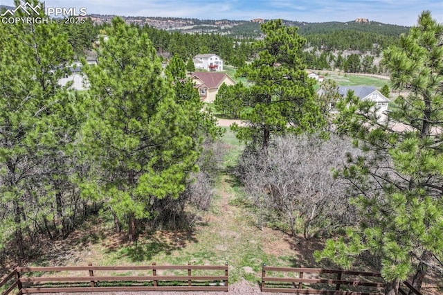 birds eye view of property featuring a wooded view