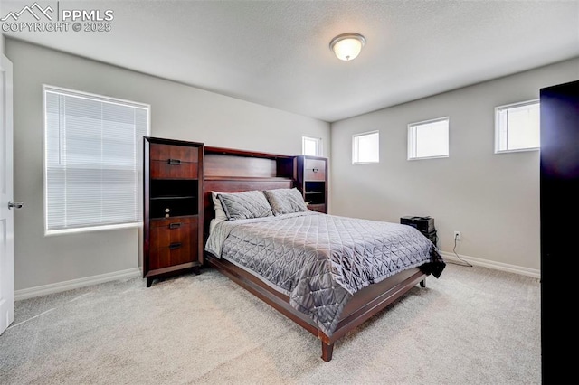 bedroom featuring carpet floors and baseboards