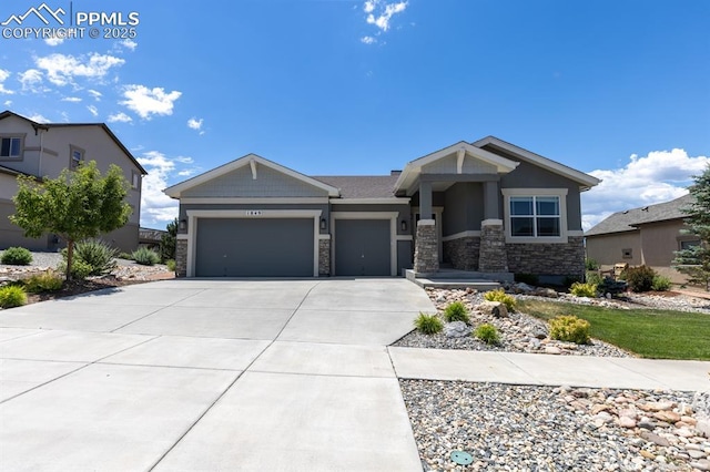 1849 Mud Hen Dr, Colorado Springs, CO 80921 - craftsman-style house featuring an attached garage, stone siding, and concrete driveway