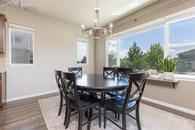 1849 Mud Hen Dr, Colorado Springs, CO 80921 - dining room featuring a chandelier, wood finished floors, and baseboards