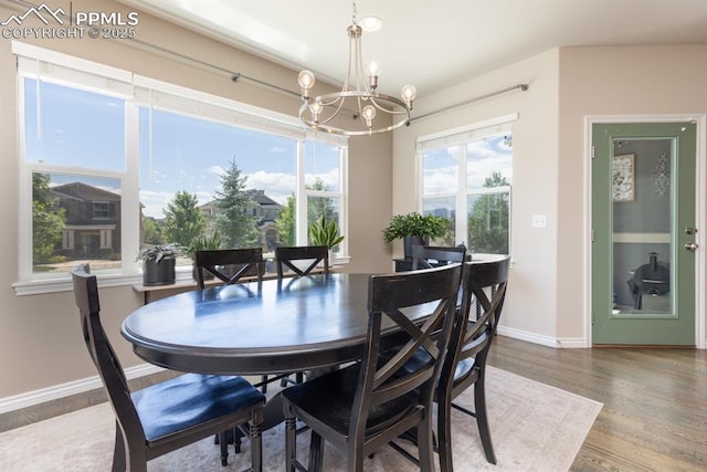 1849 Mud Hen Dr, Colorado Springs, CO 80921 - dining space featuring a chandelier, wood finished floors, and baseboards