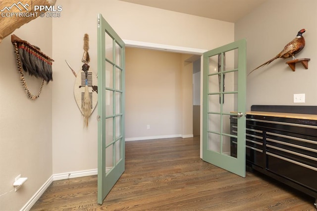 1849 Mud Hen Dr, Colorado Springs, CO 80921 - hall featuring french doors, wood finished floors, and baseboards