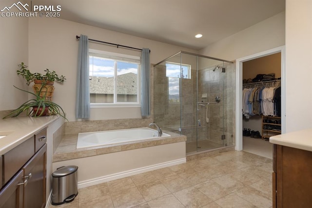 1849 Mud Hen Dr, Colorado Springs, CO 80921 - full bath with a stall shower, vanity, a garden tub, a spacious closet, and recessed lighting