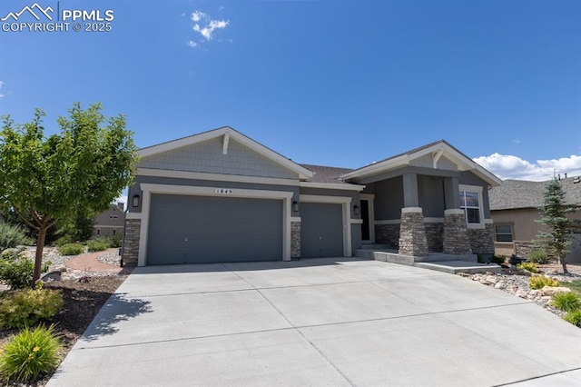 1849 Mud Hen Dr, Colorado Springs, CO 80921 - craftsman-style house featuring stone siding, an attached garage, and driveway