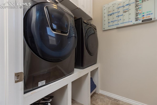1849 Mud Hen Dr, Colorado Springs, CO 80921 - washroom with cabinet space, baseboards, and washer and dryer