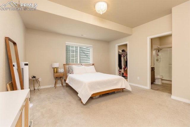 1849 Mud Hen Dr, Colorado Springs, CO 80921 - bedroom with light carpet, baseboards, a walk in closet, and ensuite bath