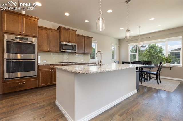 1849 Mud Hen Dr, Colorado Springs, CO 80921 - kitchen featuring stainless steel appliances, a sink, recessed lighting, dark wood-style flooring, and decorative light fixtures