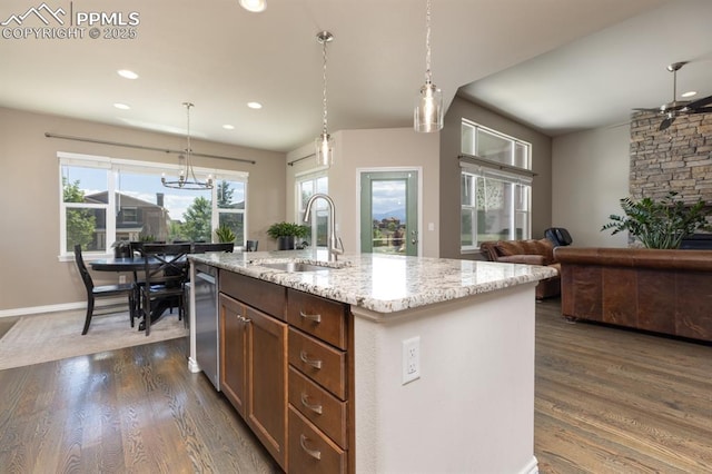 1849 Mud Hen Dr, Colorado Springs, CO 80921 - kitchen featuring a sink, dark wood-style floors, light stone countertops, recessed lighting, and decorative light fixtures