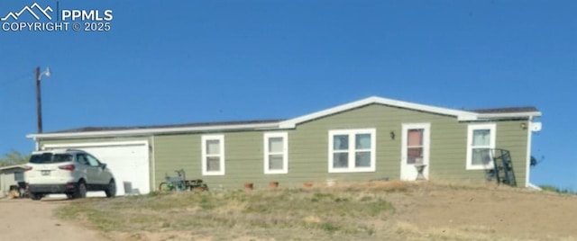 823 7th St, Hugo, CO 80821 - view of front of house featuring dirt driveway and a garage