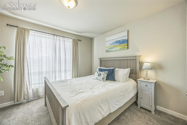 bedroom with light colored carpet and baseboards
