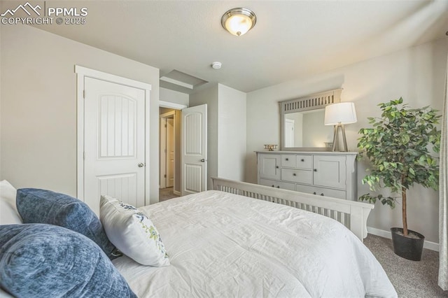 carpeted bedroom featuring baseboards