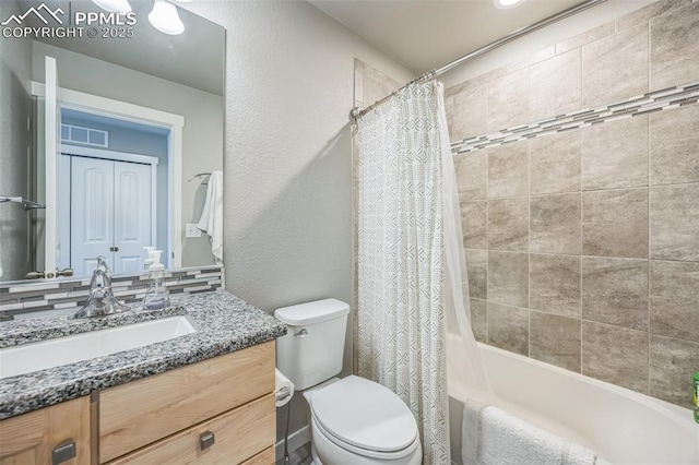 full bathroom featuring toilet, vanity, and shower / bath combination with curtain
