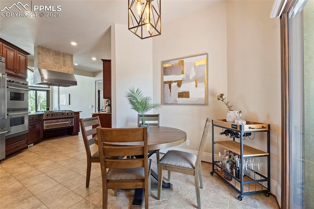 dining area with recessed lighting, baseboards, a notable chandelier, and light tile patterned flooring