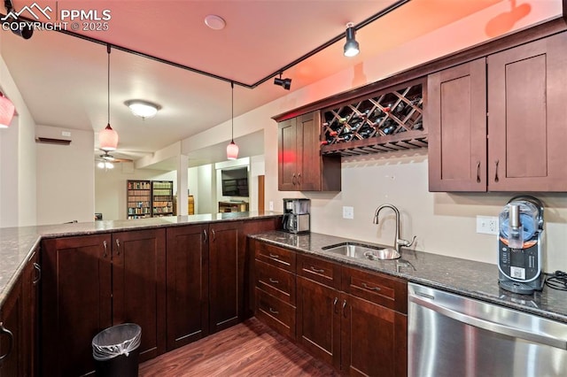 kitchen featuring ceiling fan, a sink, dark stone countertops, stainless steel dishwasher, and dark wood-style floors