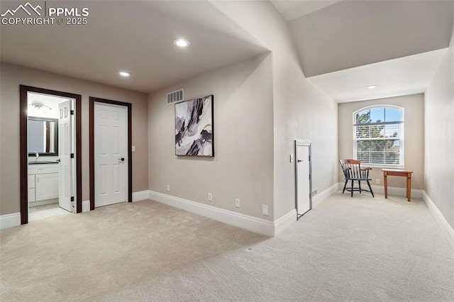 interior space with visible vents, light carpet, baseboards, recessed lighting, and a sink
