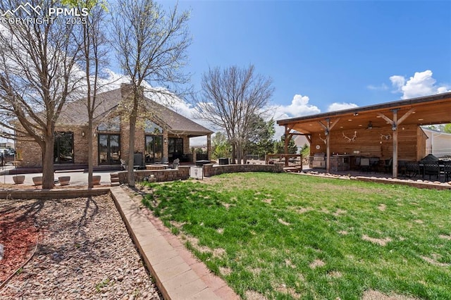 view of yard featuring ceiling fan, a patio area, and area for grilling