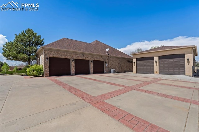 single story home featuring cooling unit and brick siding
