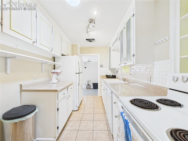 kitchen featuring visible vents, white appliances, light countertops, white cabinets, and a sink