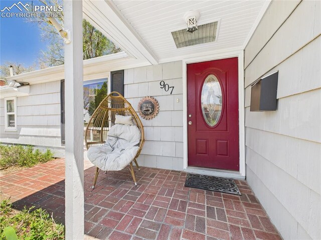 view of exterior entry featuring covered porch