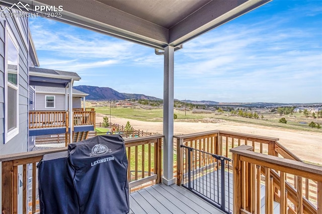 wooden terrace featuring area for grilling and a mountain view