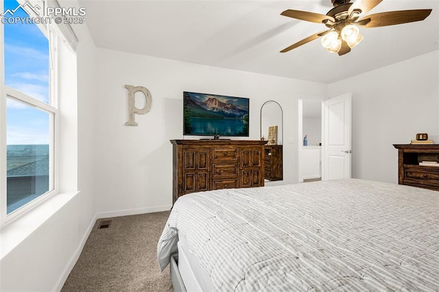 bedroom featuring carpet flooring, baseboards, visible vents, and multiple windows