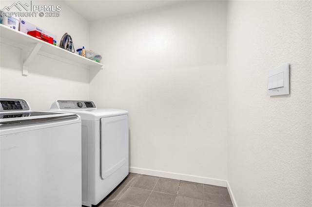 clothes washing area featuring independent washer and dryer, laundry area, baseboards, and tile patterned flooring