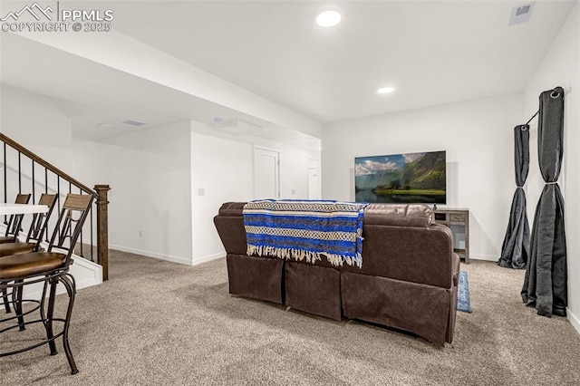 living area featuring carpet flooring, baseboards, and visible vents