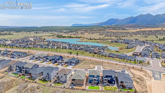 birds eye view of property with a water and mountain view and a residential view