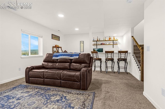 carpeted living area with stairs, recessed lighting, baseboards, and a bar