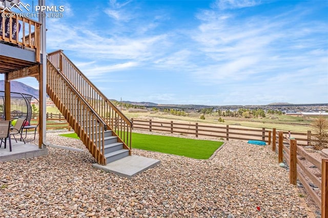 view of yard featuring stairs, fence private yard, and a patio