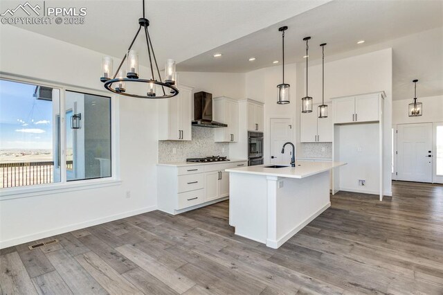 16990 Early Light Dr, Colorado Springs, CO 80908 - kitchen with an inviting chandelier, visible vents, white cabinetry, gas stovetop, and tasteful backsplash