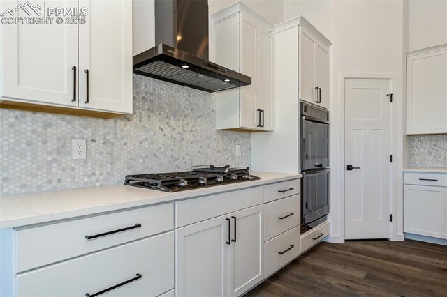 16990 Early Light Dr, Colorado Springs, CO 80908 - kitchen with wall chimney range hood, backsplash, multiple ovens, white cabinets, and black gas stovetop