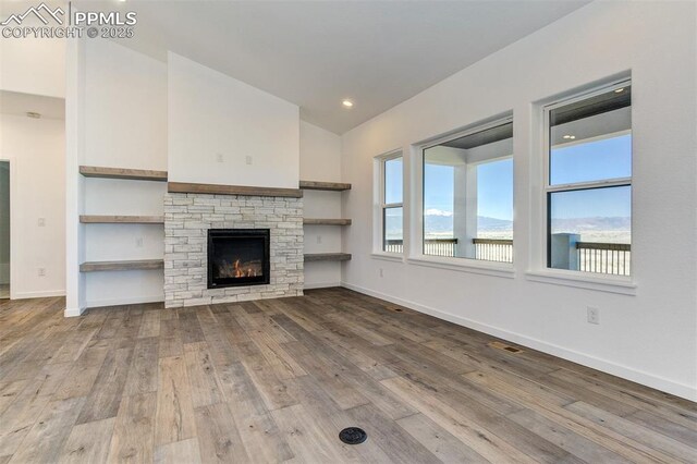 16990 Early Light Dr, Colorado Springs, CO 80908 - unfurnished living room featuring baseboards, vaulted ceiling, hardwood / wood-style flooring, and visible vents