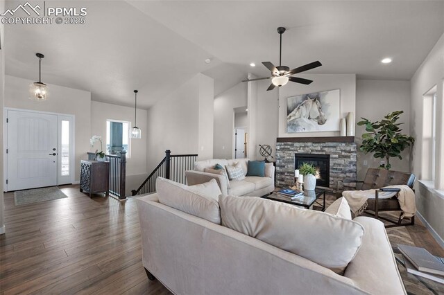 16990 Early Light Dr, Colorado Springs, CO 80908 - living room featuring a fireplace, a ceiling fan, recessed lighting, vaulted ceiling, and dark wood-style floors