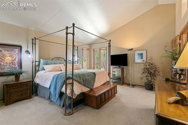 bedroom featuring vaulted ceiling and light colored carpet