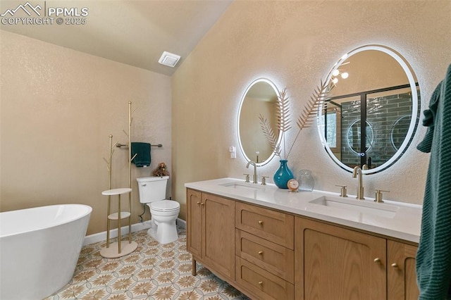 bathroom featuring a sink, vaulted ceiling, toilet, and visible vents