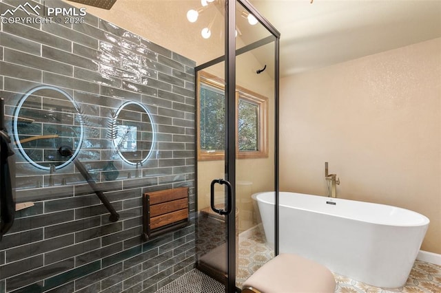 full bath with tile patterned floors, a freestanding bath, and a stall shower