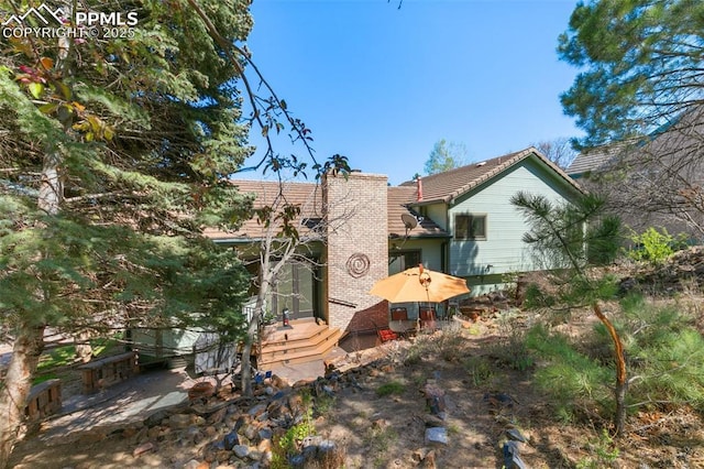 back of property featuring a chimney
