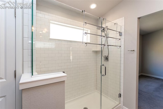 bathroom with baseboards, a shower stall, and recessed lighting
